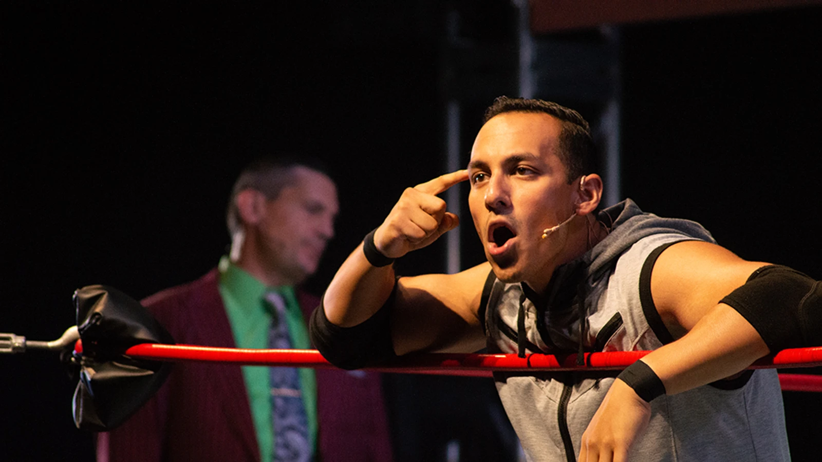 Man pointing to his head.