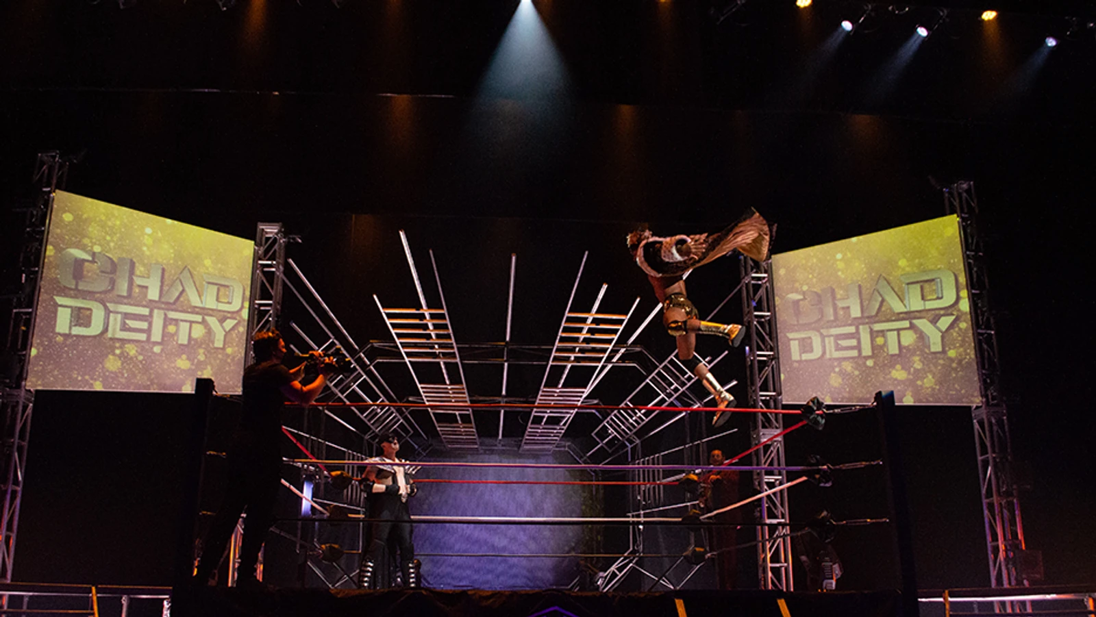 Wrestler leaping from top ropes at another wrestler
