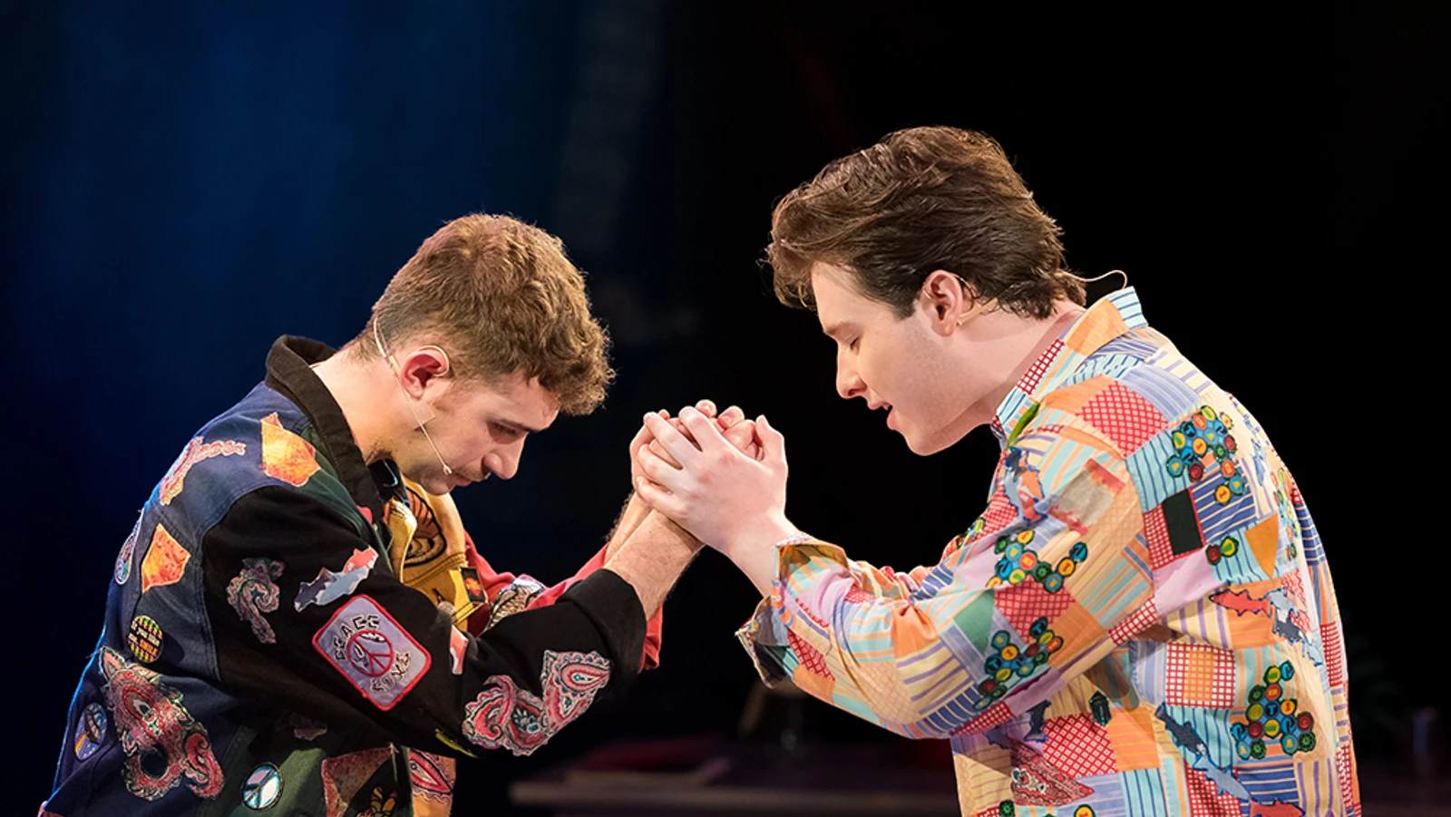 Two men holding hands together in Prayer